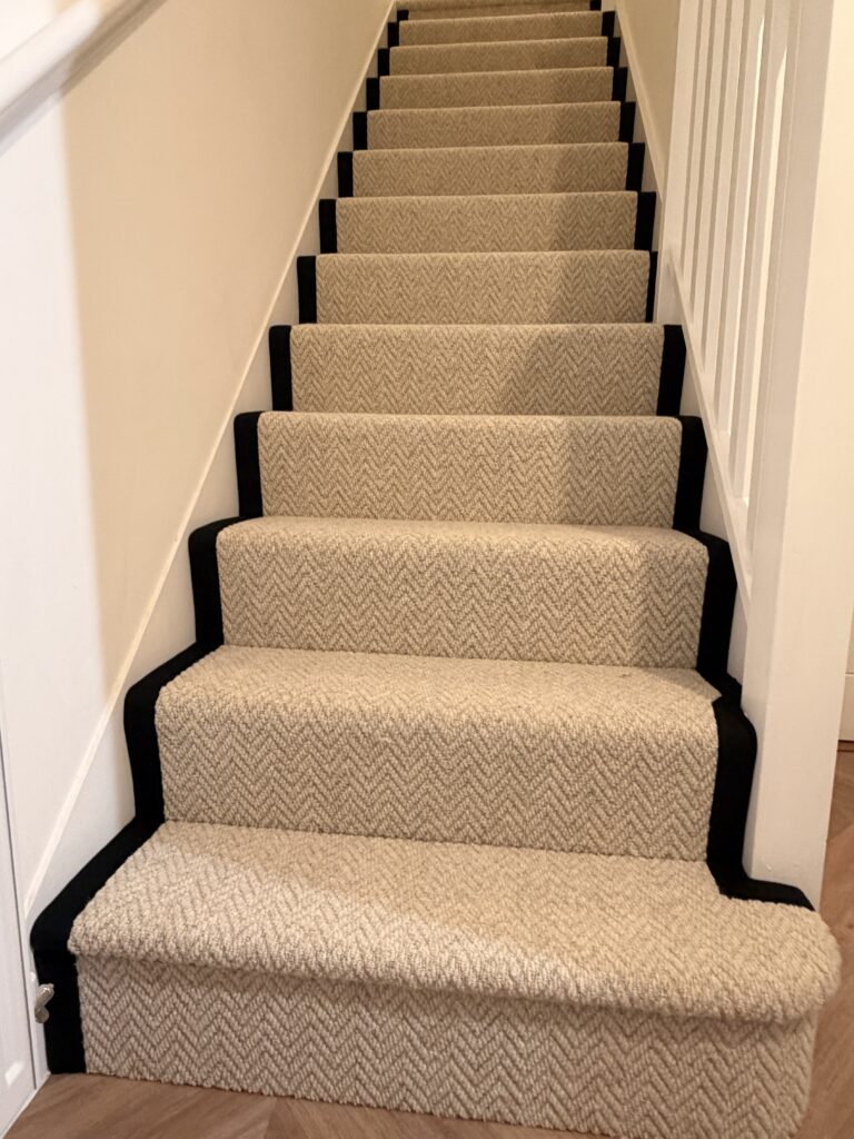Black-edged herringbone stair runner fitted by DL Carpets and Flooring